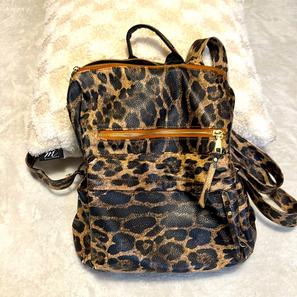 Modern + Chic backpack purse. Has many pockets.  Perfect for family trips.